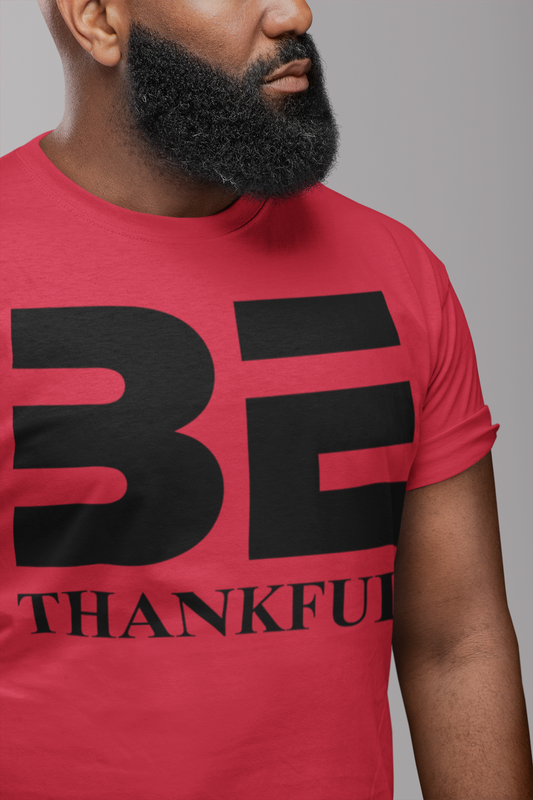 male with red shirt with black text showing BE Thankful